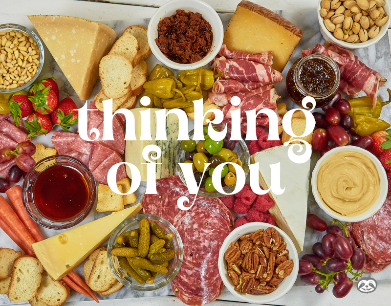Greeting Card Cover of cured meats, cheeses, nuts, and pickles, and the words "Thinking of You"