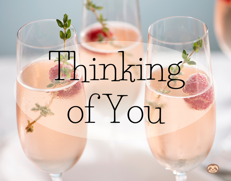 Greeting Card Cover of three glasses of pink champagne, raspberries, and thyme, and the words Thinking of You"